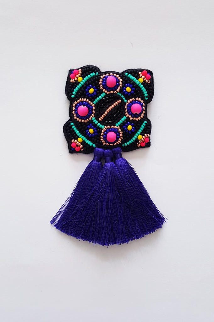 Bright and colorful Ancient brooch with tassels