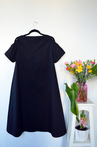 Fresh and New Spring Summer 2018 Black Cotton Dress with Contrast Pockets and Naked Shoulder Detail.
